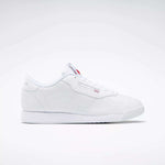 The Reebok Women's Princess Shoes feature a classic white design with a flat sole, cushioned comfort, and subtle branding on the side and tongue—a timeless choice displayed on a plain light background.