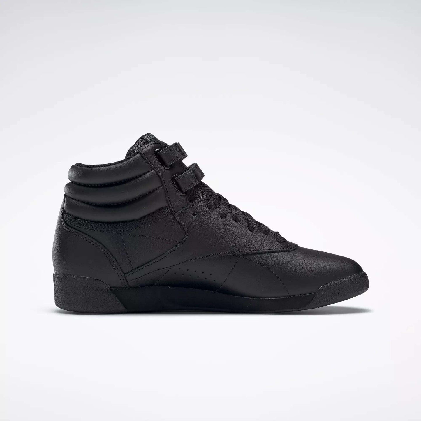 The Reebok Women's Freestyle Hi Shoes are black high tops with a padded ankle collar, lace-up front, and two hook-and-loop straps—ideal for women's fitness and shown on a plain white background.