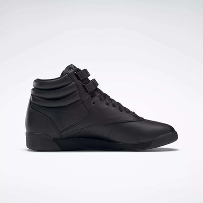 The Reebok Women's Freestyle Hi Shoes are black high tops with a padded ankle collar, lace-up front, and two hook-and-loop straps—ideal for women's fitness and shown on a plain white background.
