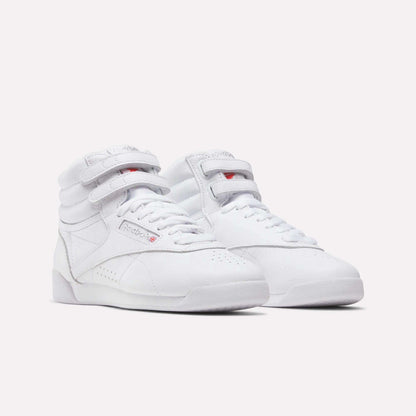 Reebok Women's Freestyle Hi Shoes in white feature high-tops, velcro straps, and laces—ideal for fitness—shown on a plain white background.