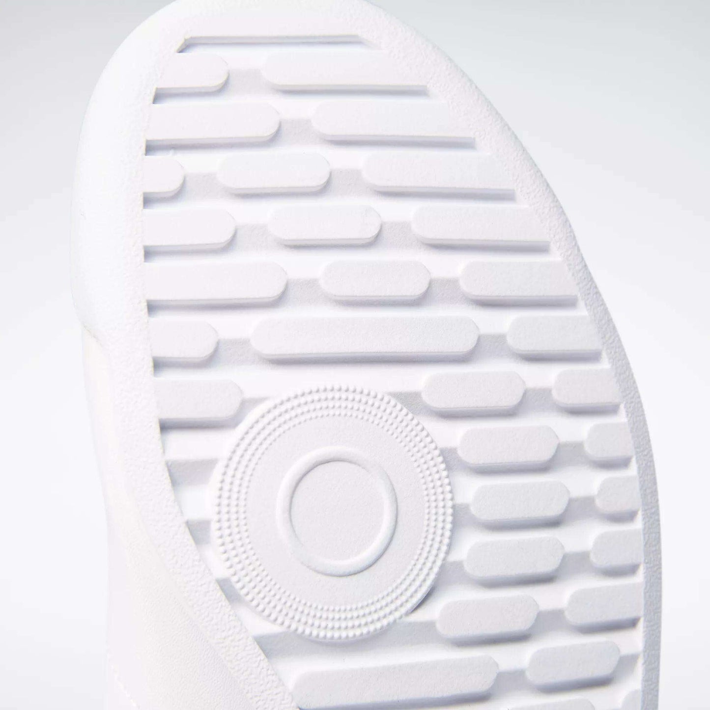 Close-up of the textured white sole on Reebok Women's Princess Wide Shoes, showing horizontal grooves, a central circular pattern, and heritage cushion detailing for comfort.