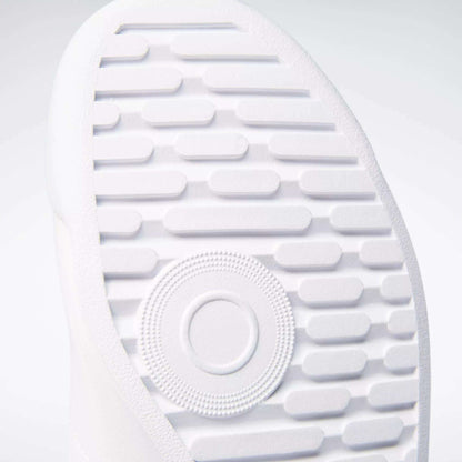 Close-up of the textured white sole on Reebok Women's Princess Wide Shoes, showing horizontal grooves, a central circular pattern, and heritage cushion detailing for comfort.