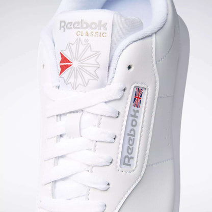 Close-up of a classic women's shoe: the Reebok Women's Princess Wide Shoe in white, featuring signature branding and heritage cushion comfort with neatly tied white laces.