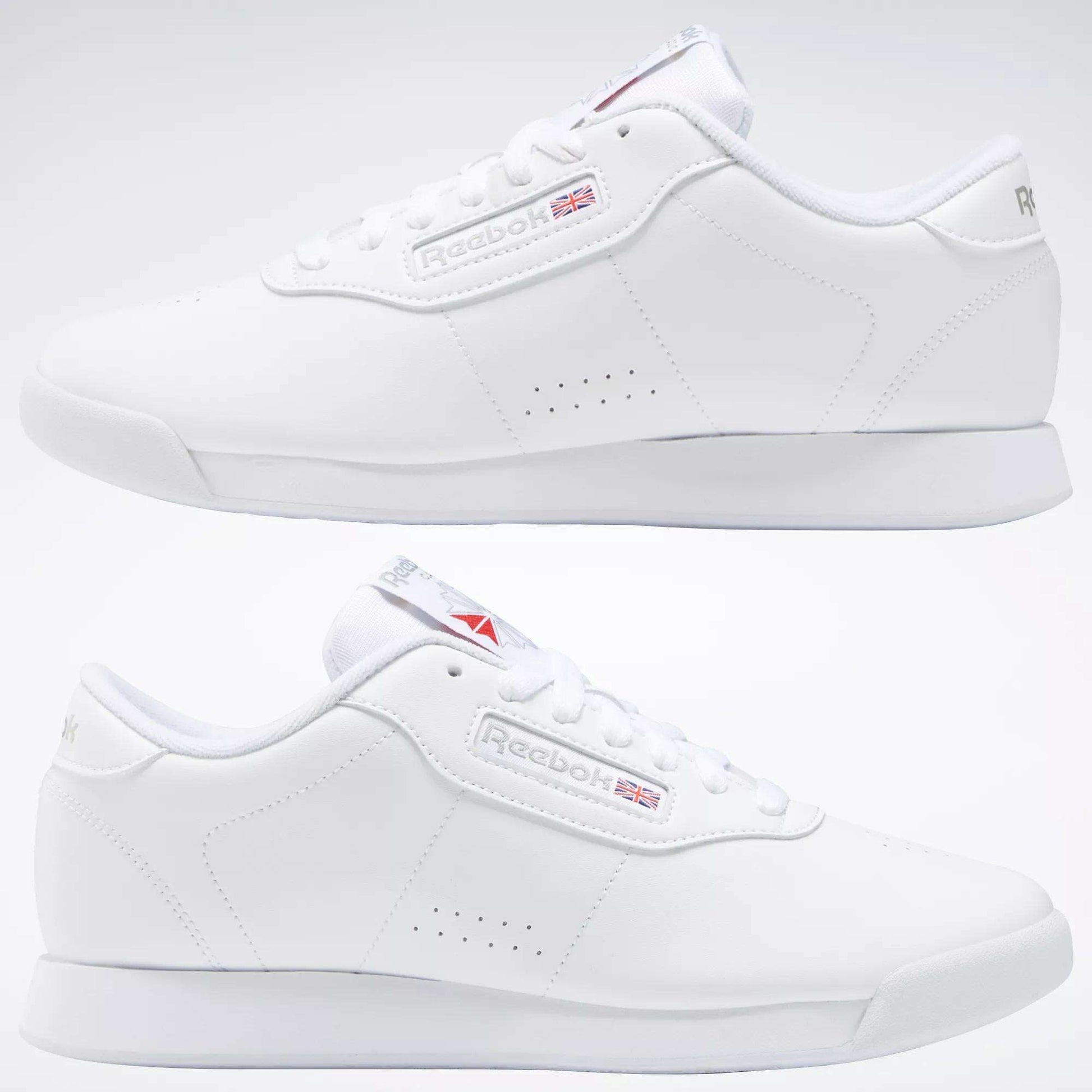 A pair of Reebok Women's Princess Wide Shoes with a minimal design, iconic Union Jack logo, and heritage cushioning, displayed from left and right angles on a plain background.