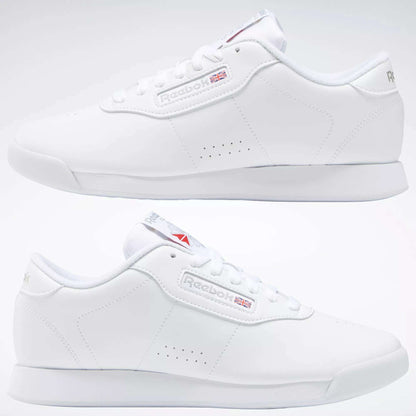 A pair of Reebok Women's Princess Wide Shoes with a minimal design, iconic Union Jack logo, and heritage cushioning, displayed from left and right angles on a plain background.
