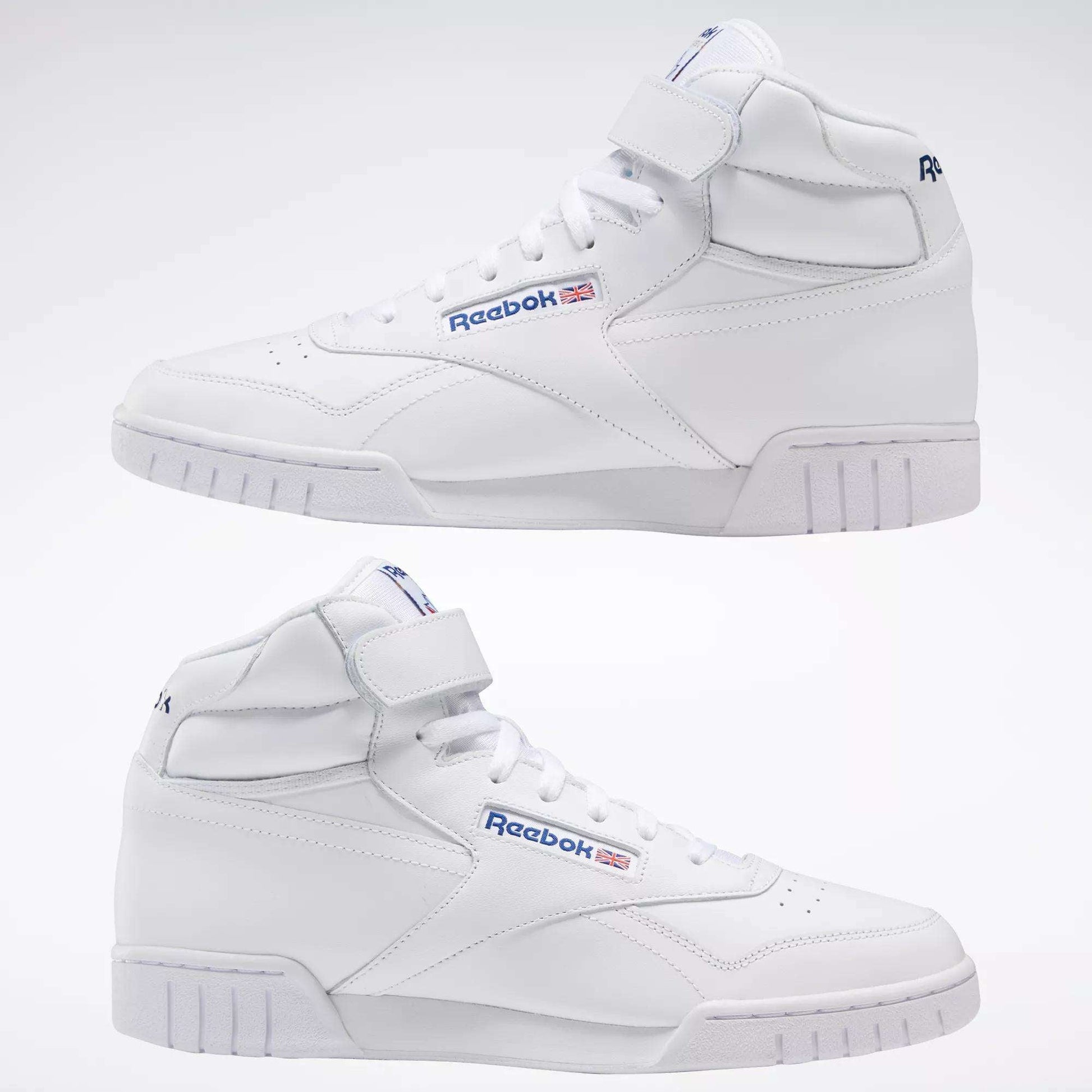 The Reebok Men's EX-O-FIT Hi Shoes are white leather high-tops with blue and red logos, strap closures at the ankle, and a clean retro design. Two shoes are shown side by side on a plain light background.