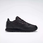 The Reebok Kids' Classic Leather Shoes - Preschool feature a black leather upper, low-top silhouette, lace-up closure, and subtle side branding, shown against a plain white background.