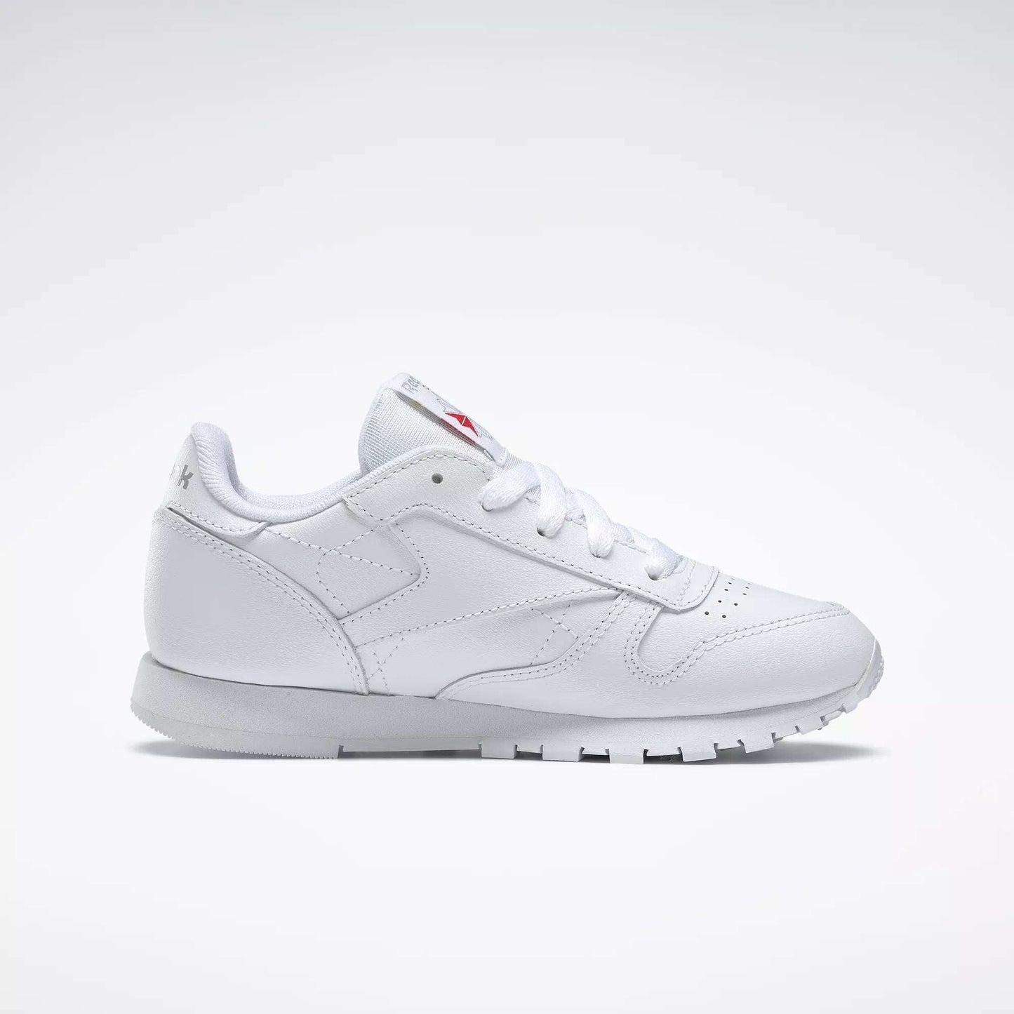 The Reebok Kids' Classic Leather Shoes – Preschool, featuring a white leather upper, white laces, and a rubber sole, is displayed in a side view on a light gray background.