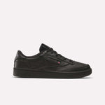 The Reebok Club C 85 Shoes feature a black leather upper, black sole, and black laces in a low-top design, shown in side profile on a plain white background.