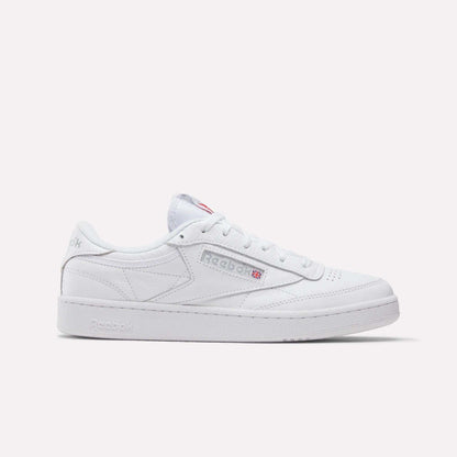 The Reebok Club C 85 Shoes feature a white leather upper with gray stitching, low-top tennis-inspired design, Reebok logo with Union Jack on the side, and white laces and sole against a plain background.