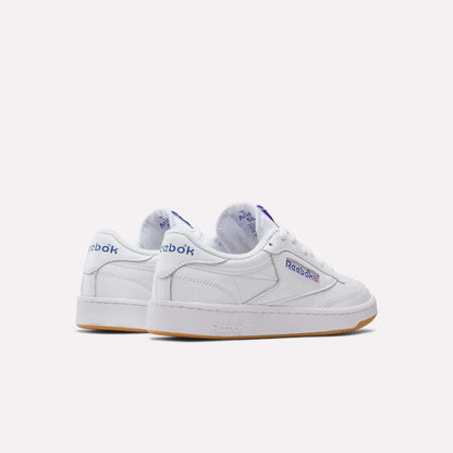 A pair of Reebok Club C 85 Shoes in white leather with blue and red logo details, gum rubber soles, and clean stitching, displayed on a plain white background.