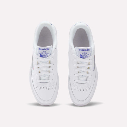 A top view of Reebok Club C 85 Shoes in white leather, featuring purple Reebok branding on the tongue and side, classic white laces, and perforated toe detailing for a timeless tennis-inspired style.