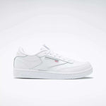 The Kids' Club C Shoes – Grade School by Reebok are white low-top sneakers with soft leather uppers, the Reebok logo, and a small Union Jack flag on the side, shown on a plain white background.