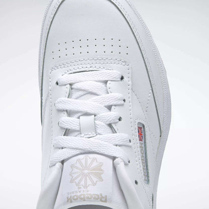 Close-up of the Reebok Kids' Club C Shoes - Grade School, showcasing the top view with laces, Reebok logo with Union Jack side detail, and soft leather uppers for timeless comfort.