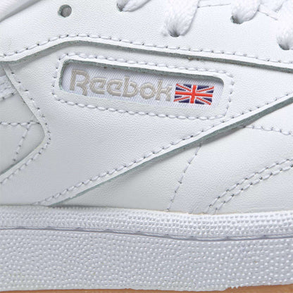 Close-up of Kids' Club C Shoes - Grade School by Reebok, showcasing soft leather uppers, stitched branding, and a small Union Jack flag on the side of this classic sneaker.