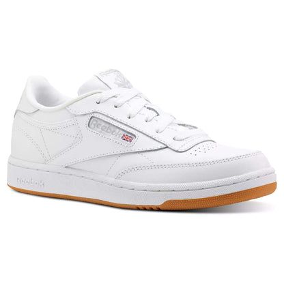 The Kids' Club C Shoes - Grade School by Reebok feature soft white leather uppers, a gum sole, classic white laces, and the iconic Reebok logo with a Union Jack flag for timeless court-inspired style.