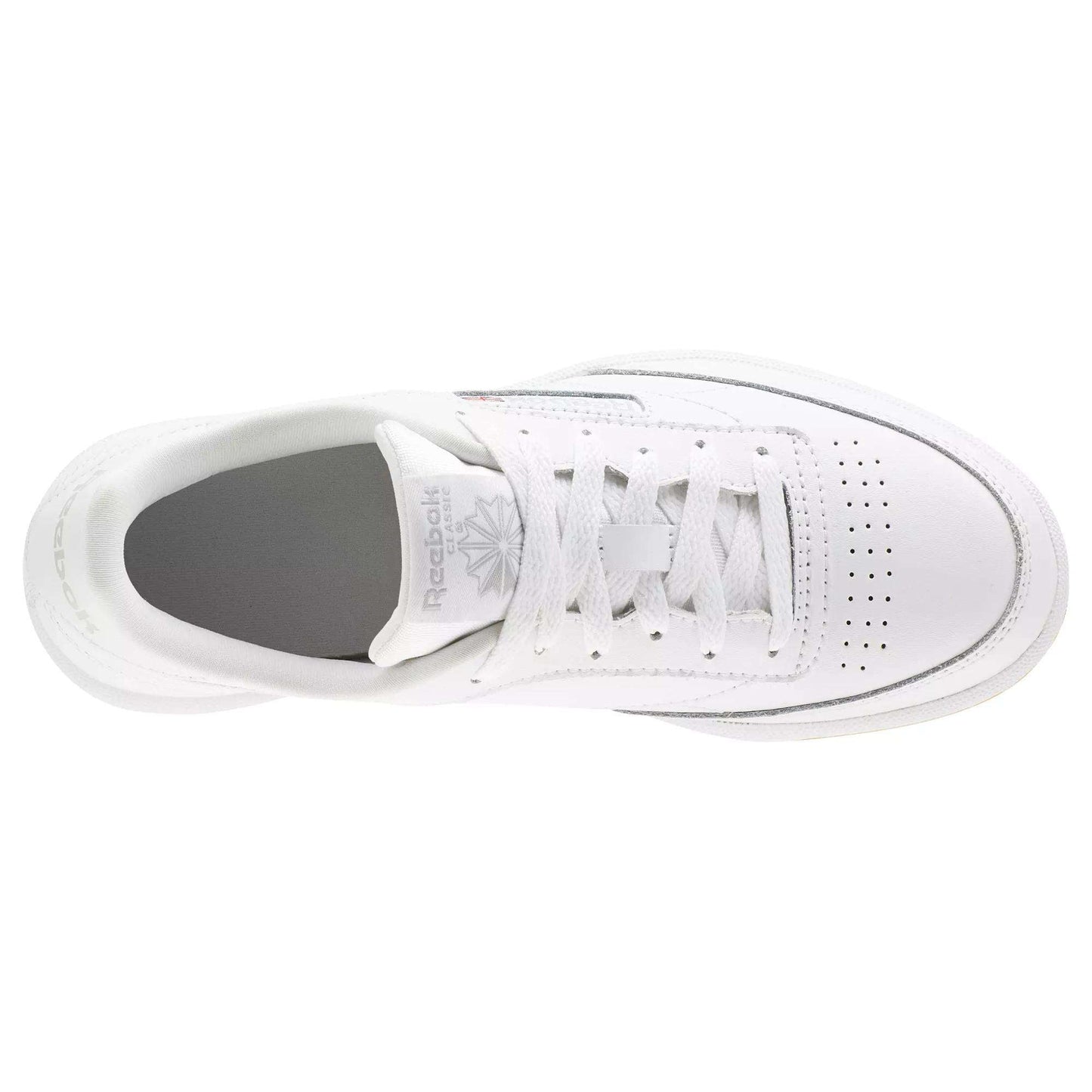 Top view of Reebok Kids' Club C Shoes - Grade School: white sneaker with soft leather uppers, white laces, toe perforations, a grey insole, and the Reebok logo on the tongue for signature style.