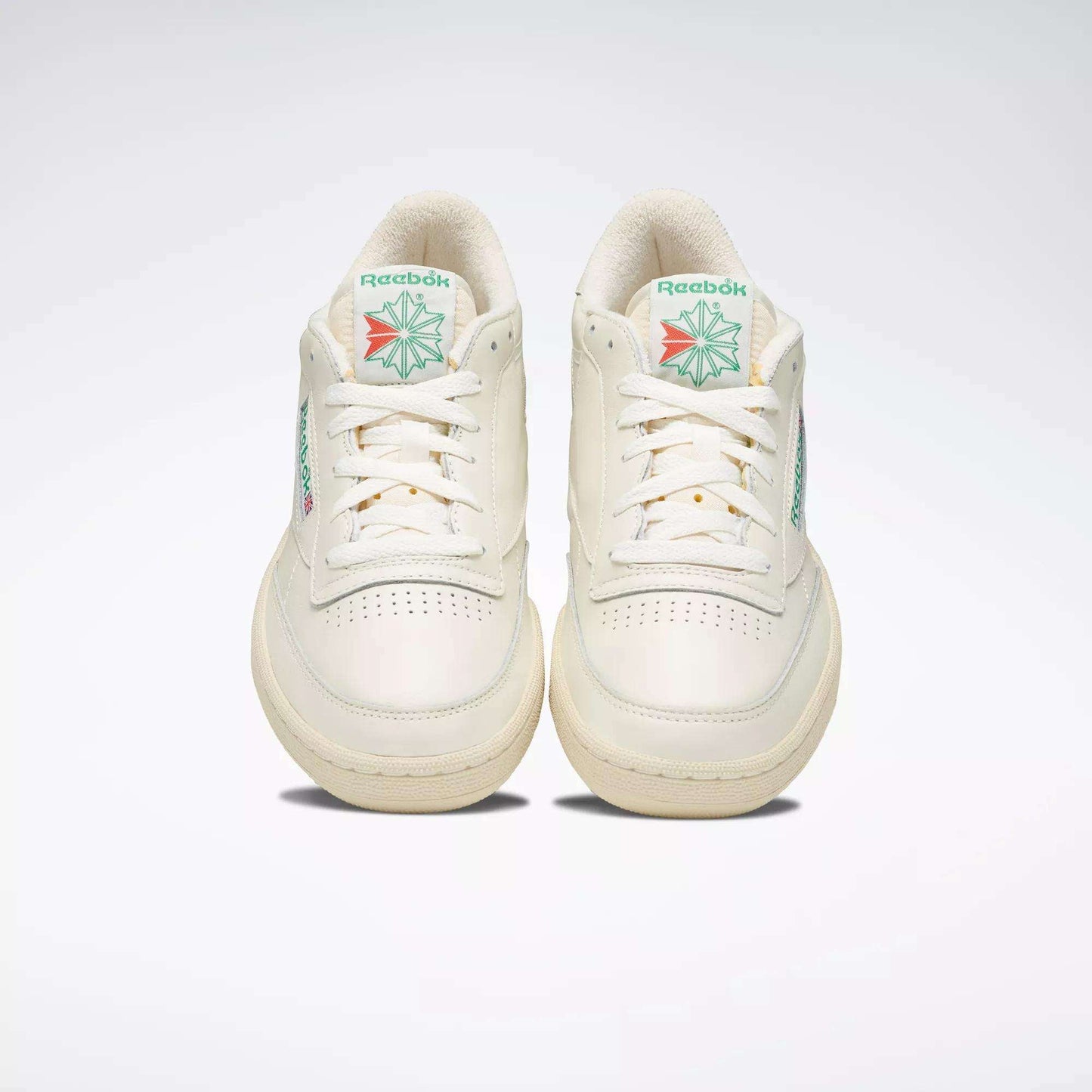 A pair of off-white Reebok Club C 85 Vintage Shoes with leather uppers and green and red logo details on the tongue, shown from the front against a plain light background.