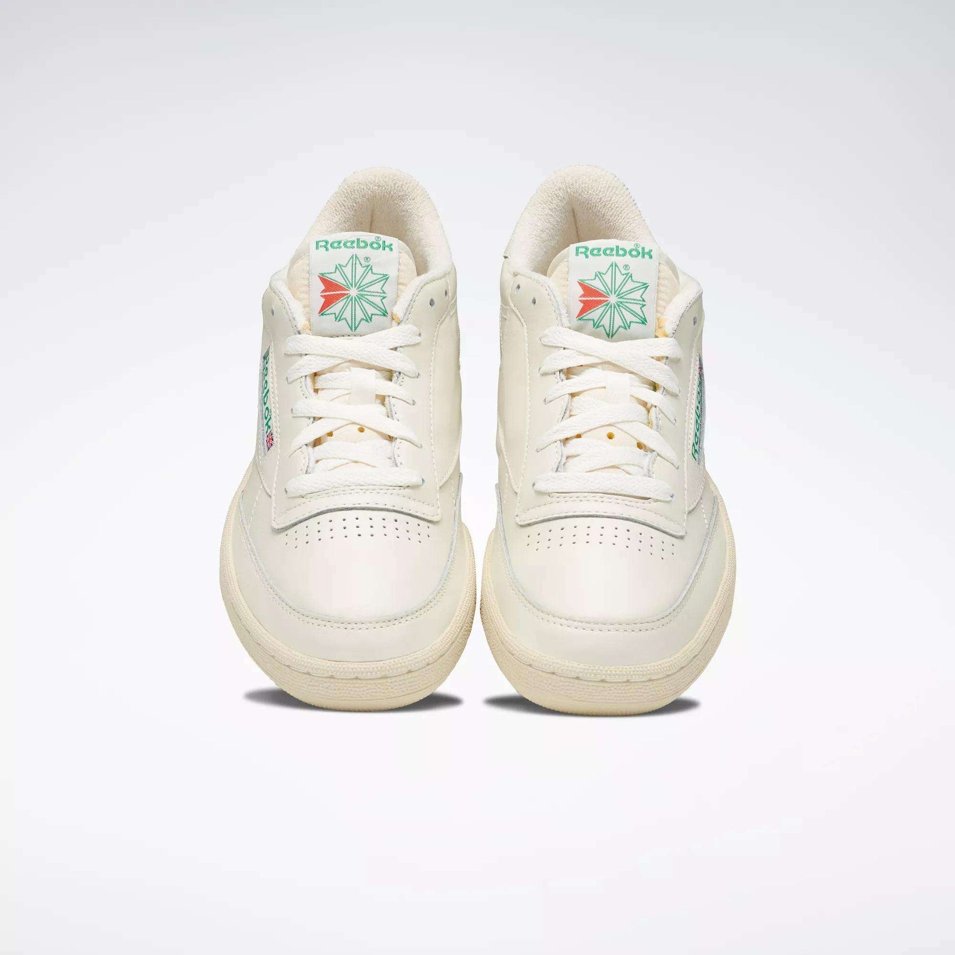 A pair of off-white Reebok Club C 85 Vintage Shoes with leather uppers and green and red logo details on the tongue, shown from the front against a plain light background.