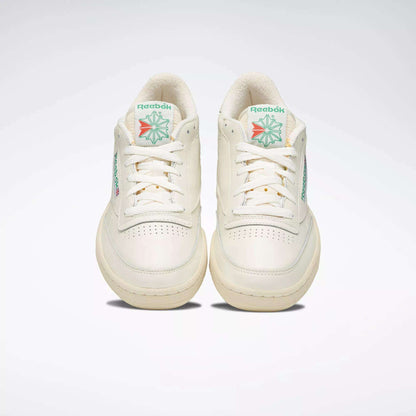 A pair of off-white Reebok Club C 85 Vintage Shoes with leather uppers and green and red logo details on the tongue, shown from the front against a plain light background.