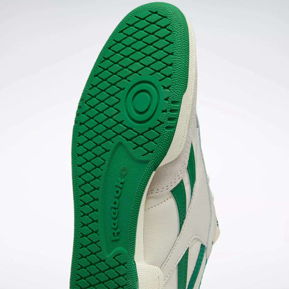 Close-up of the green and white sole of Reebok's Men's Club C Revenge Vintage Shoes, featuring a textured grip pattern and embossed Reebok logo for subtle retro flair.