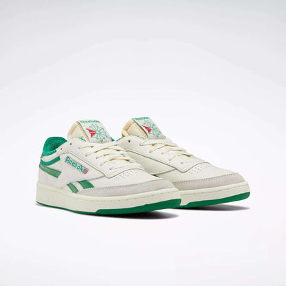 The Men's Club C Revenge Vintage Shoes by Reebok feature off-white leather, green accents and soles, plus classic branding for a retro tennis-inspired look, shown against a white background.