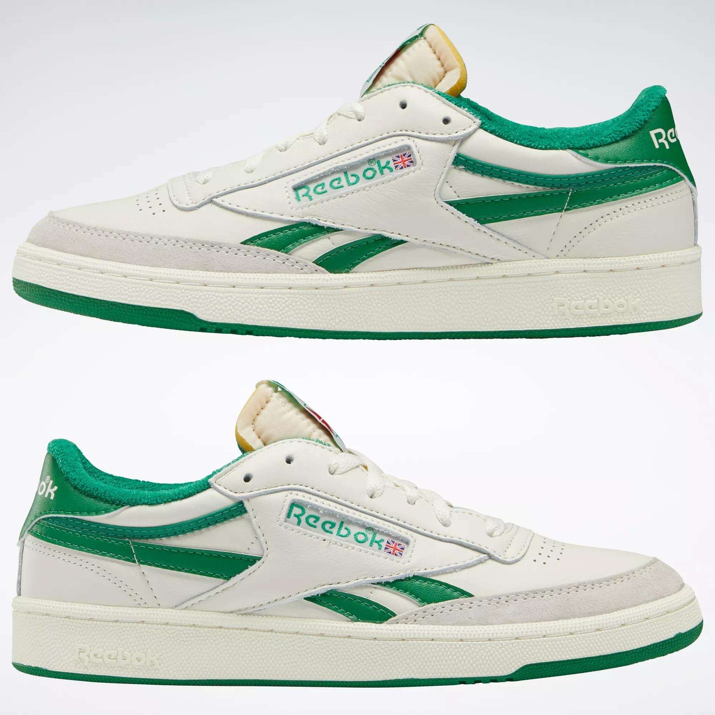 Men's Club C Revenge Vintage Shoes by Reebok, shown from the side on a plain background. These white sneakers feature green accents, a green heel, vintage-style leather, plus the Reebok logo and Union Jack on the side.