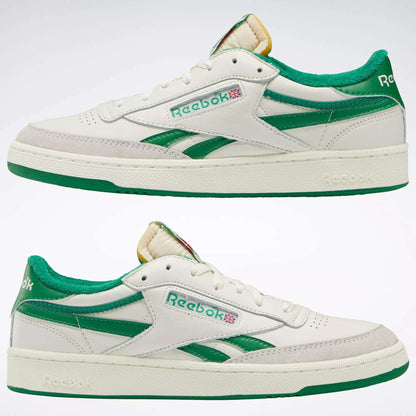 Men's Club C Revenge Vintage Shoes by Reebok, shown from the side on a plain background. These white sneakers feature green accents, a green heel, vintage-style leather, plus the Reebok logo and Union Jack on the side.