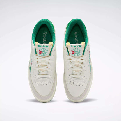 A top view of the Men's Club C Revenge Vintage Shoes by Reebok, white with green interiors and accents. These tennis-inspired sneakers feature the Reebok logo, tongue detailing, and perforated toes for retro style.
