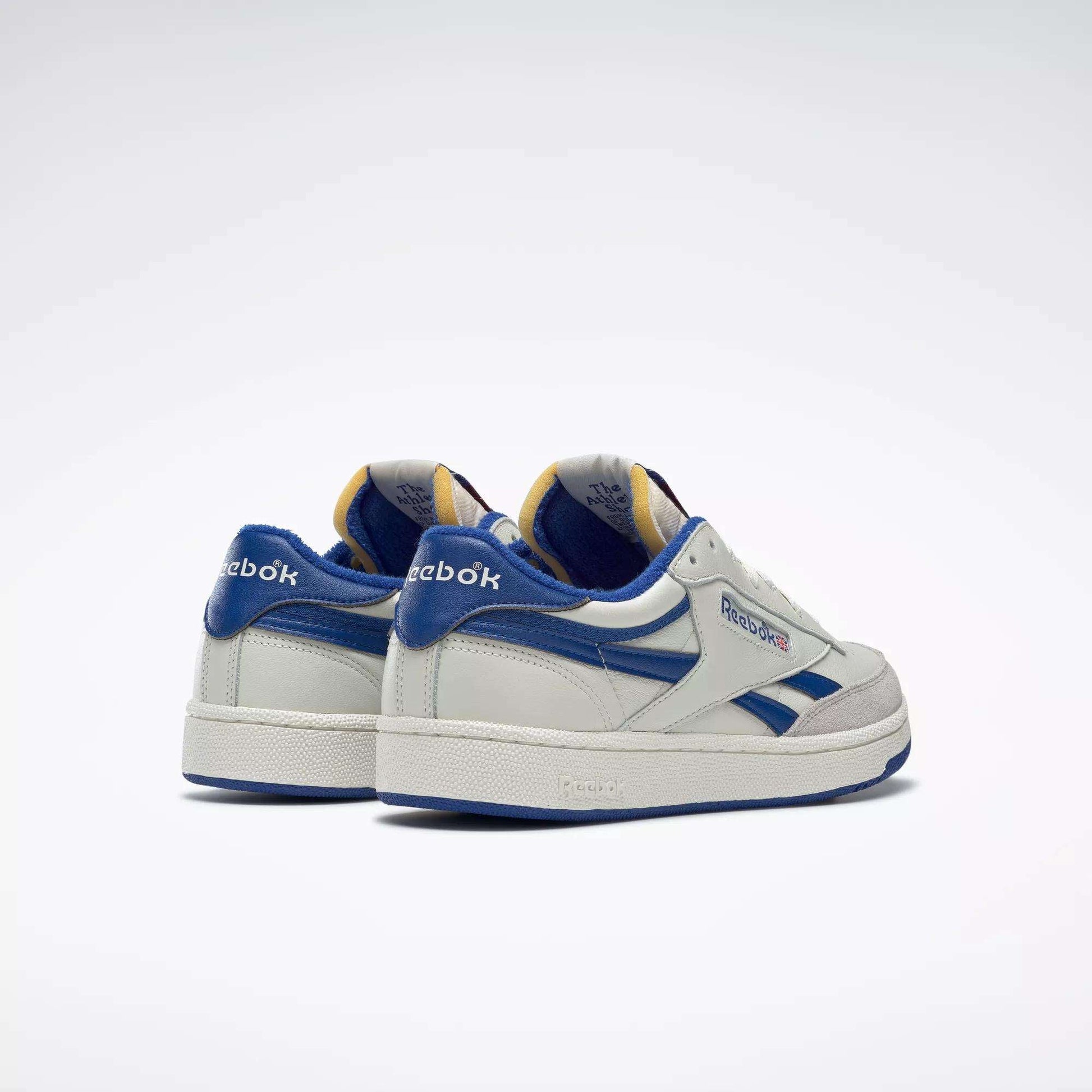 Men's Club C Revenge Vintage Shoes by Reebok in white vintage-style leather with blue accents and branding, shown from the back and side on a plain white background.