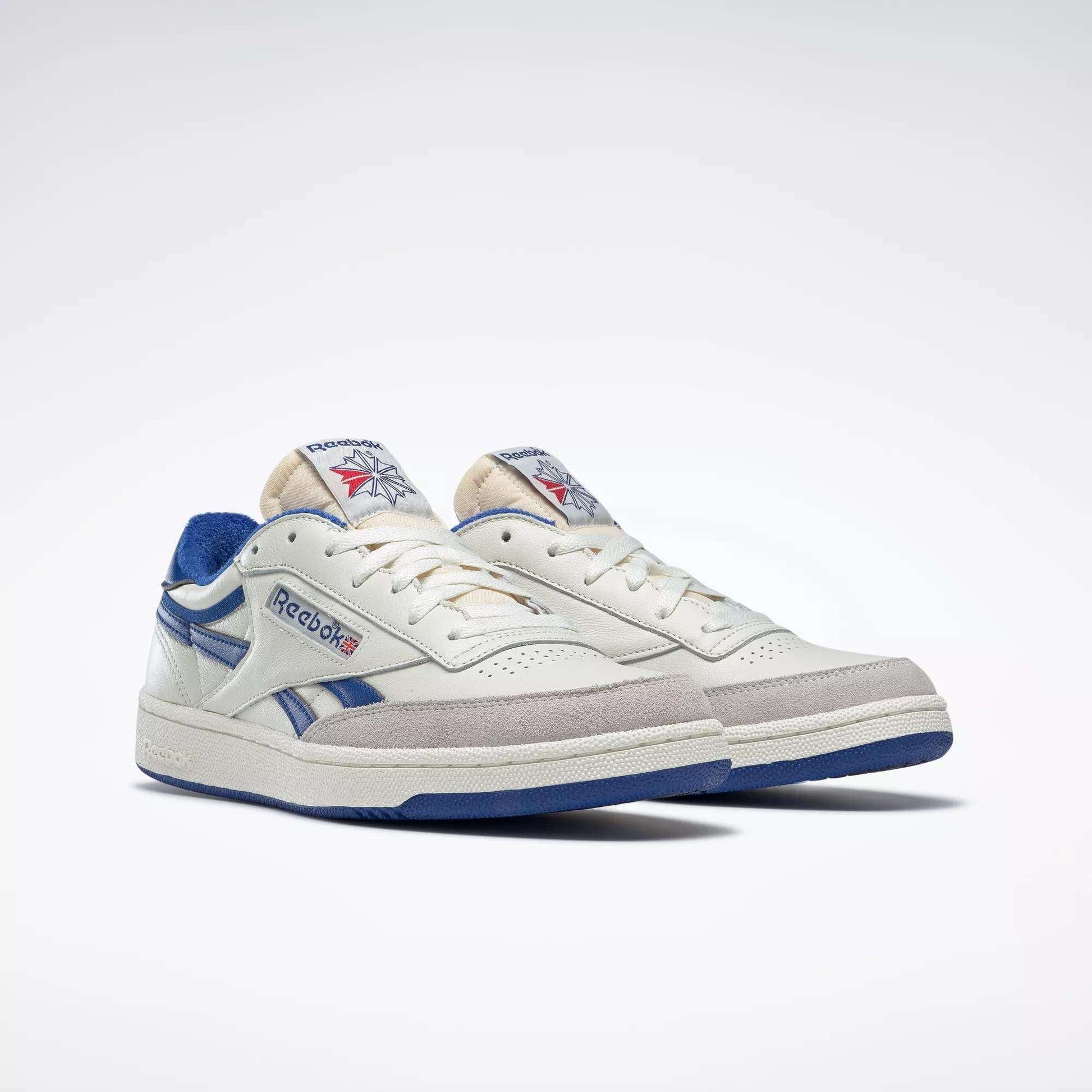 The Reebok Men's Club C Revenge Vintage Shoes in off-white with blue accents feature vintage-style leather and classic retro design details, shown on a plain white background.