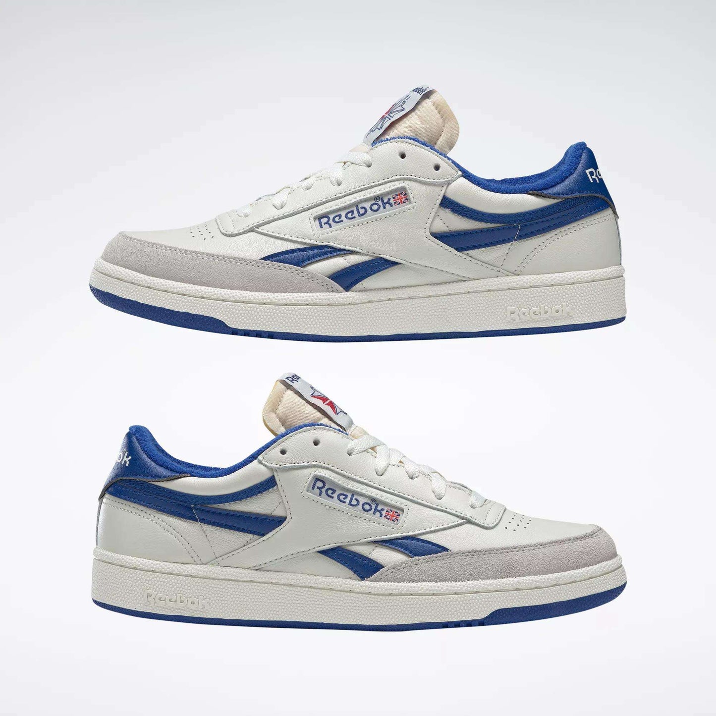 The Reebok Men's Club C Revenge Vintage Shoes feature classic white leather with blue accents and the iconic Reebok logo plus Union Jack flag on the side, shown against a plain light background.