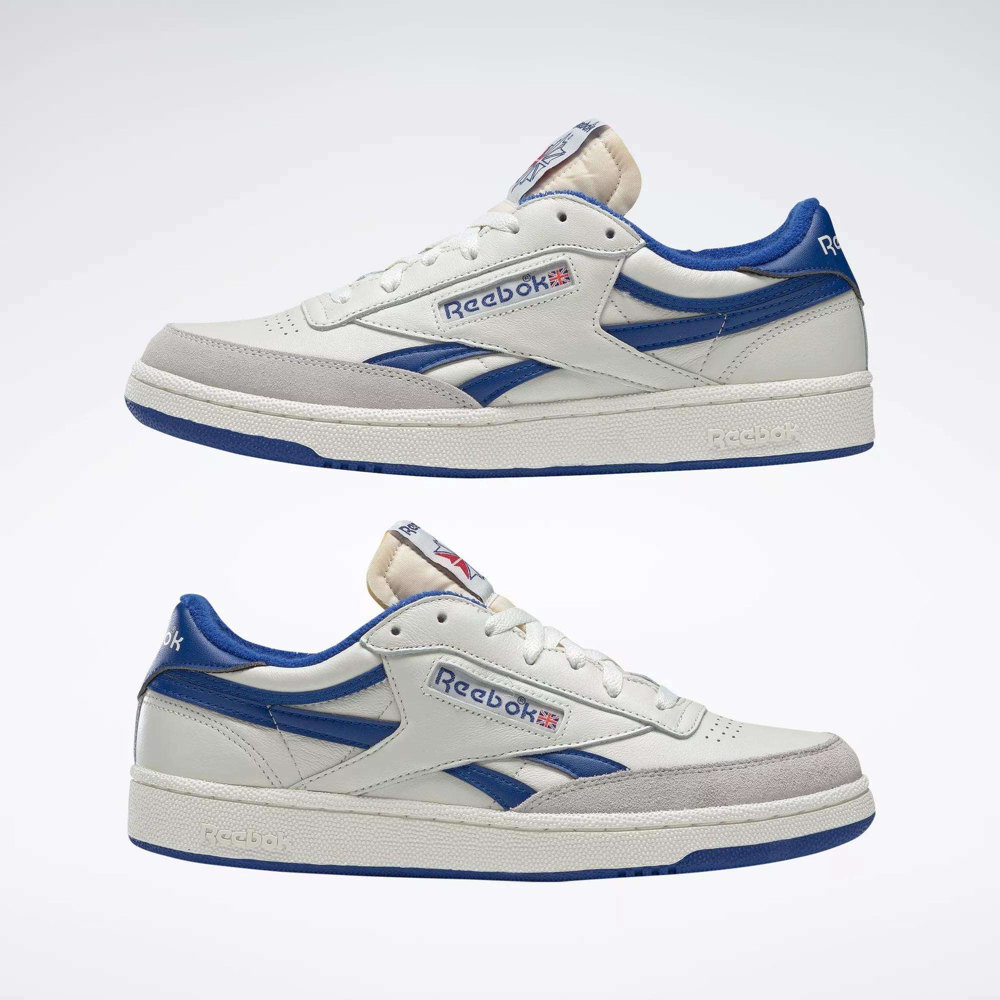 The Reebok Men's Club C Revenge Vintage Shoes feature classic white leather with blue accents and the iconic Reebok logo plus Union Jack flag on the side, shown against a plain light background.