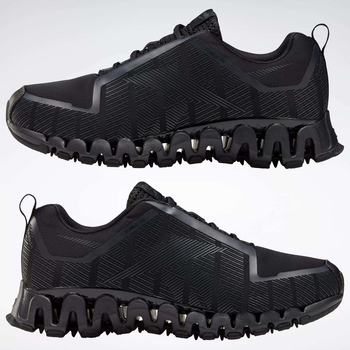 The Reebok Men's ZigWild Trail 6 Shoes in black feature geometric patterns and unique zigzag soles with enhanced cushioning, displayed in profile view against a plain light background.