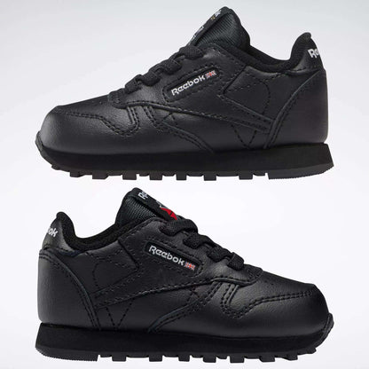 Two pairs of Reebok Kids' Classic Leather Shoes for babies and toddlers are displayed side by side on a white background, showcasing their classic sneaker design and signature branding.
