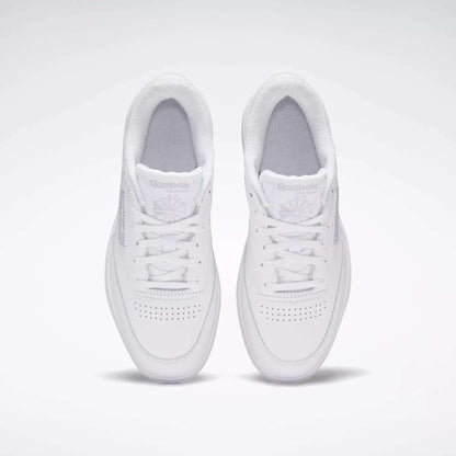 A pair of Reebok Women's Club C Double Shoes in white, seen from above on a light background, highlighting the perforated toe and Reebok logo on each tongue.