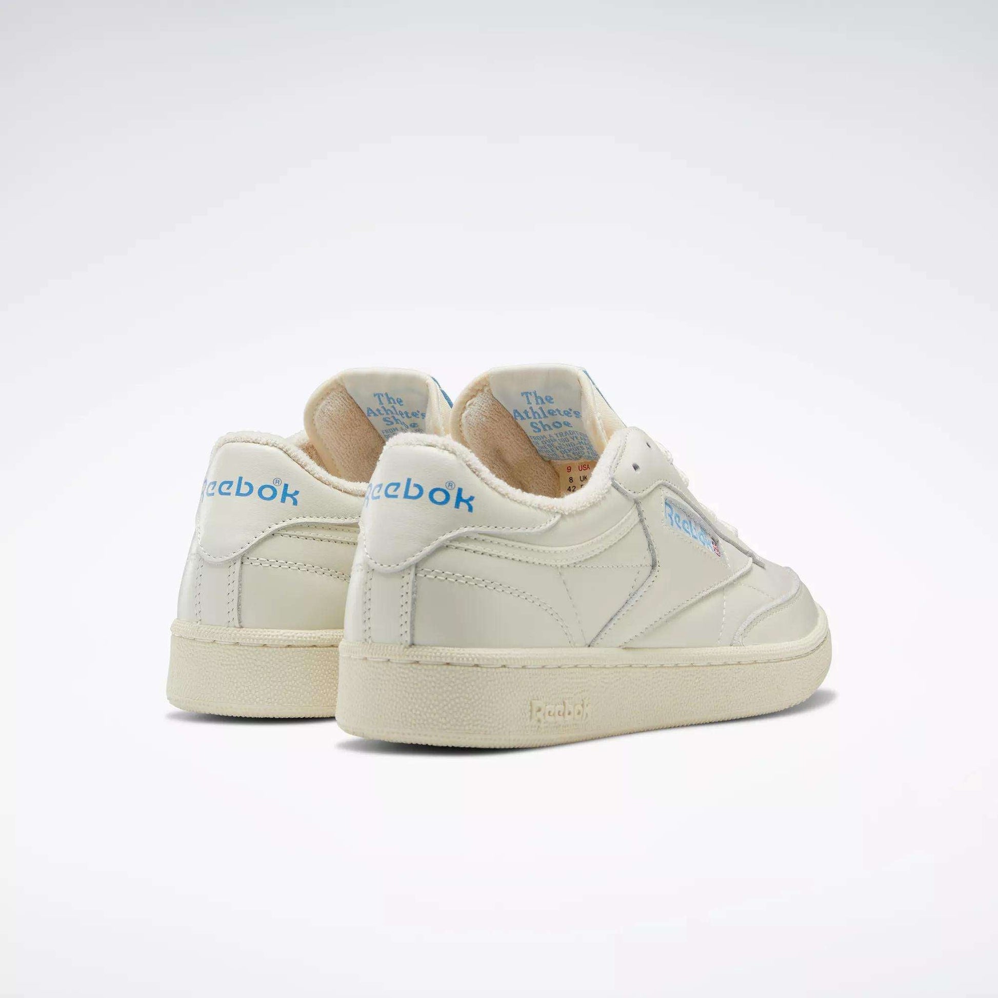A pair of Reebok Club C 85 Vintage shoes with a leather upper and light blue Reebok branding on the heel and side, shown at an angle on a plain light background.