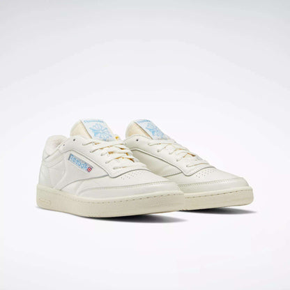 A pair of Reebok Club C 85 Vintage Shoes in off-white with blue and red logo accents, featuring a classic low-top leather upper and cream soles, displayed on a plain white background.