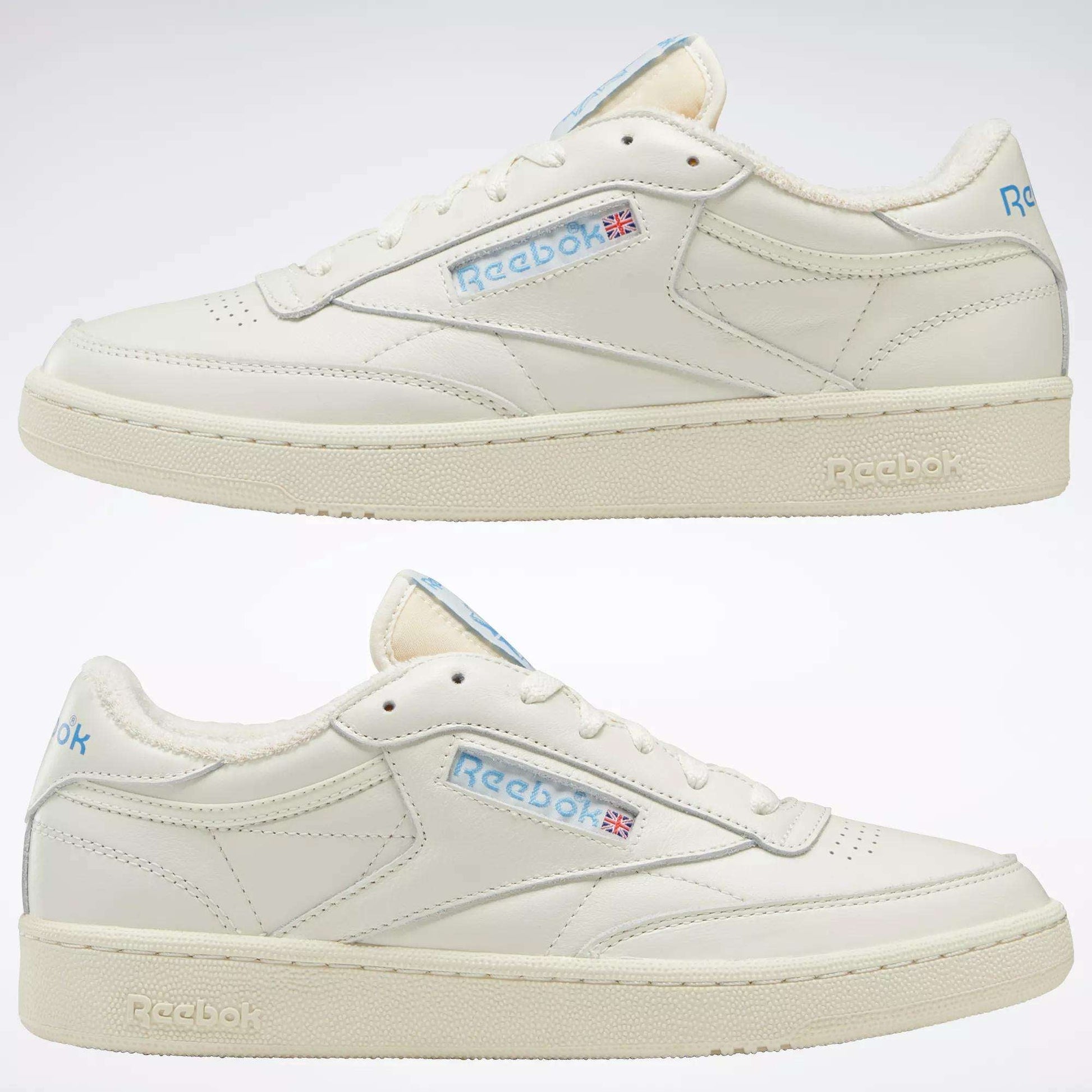 A pair of Reebok Club C 85 Vintage Shoes in off-white featuring a leather upper, light blue accents, the Reebok logo with a Union Jack flag, cream-colored soles, and lightweight cushioning for classic comfort.