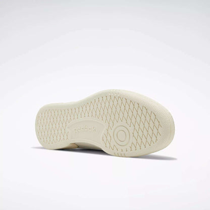 The image displays the sole of a beige Reebok Club C 85 Vintage Shoe against a light background. The sneaker features a diamond-patterned tread with the Reebok logo and a circular design in the center.