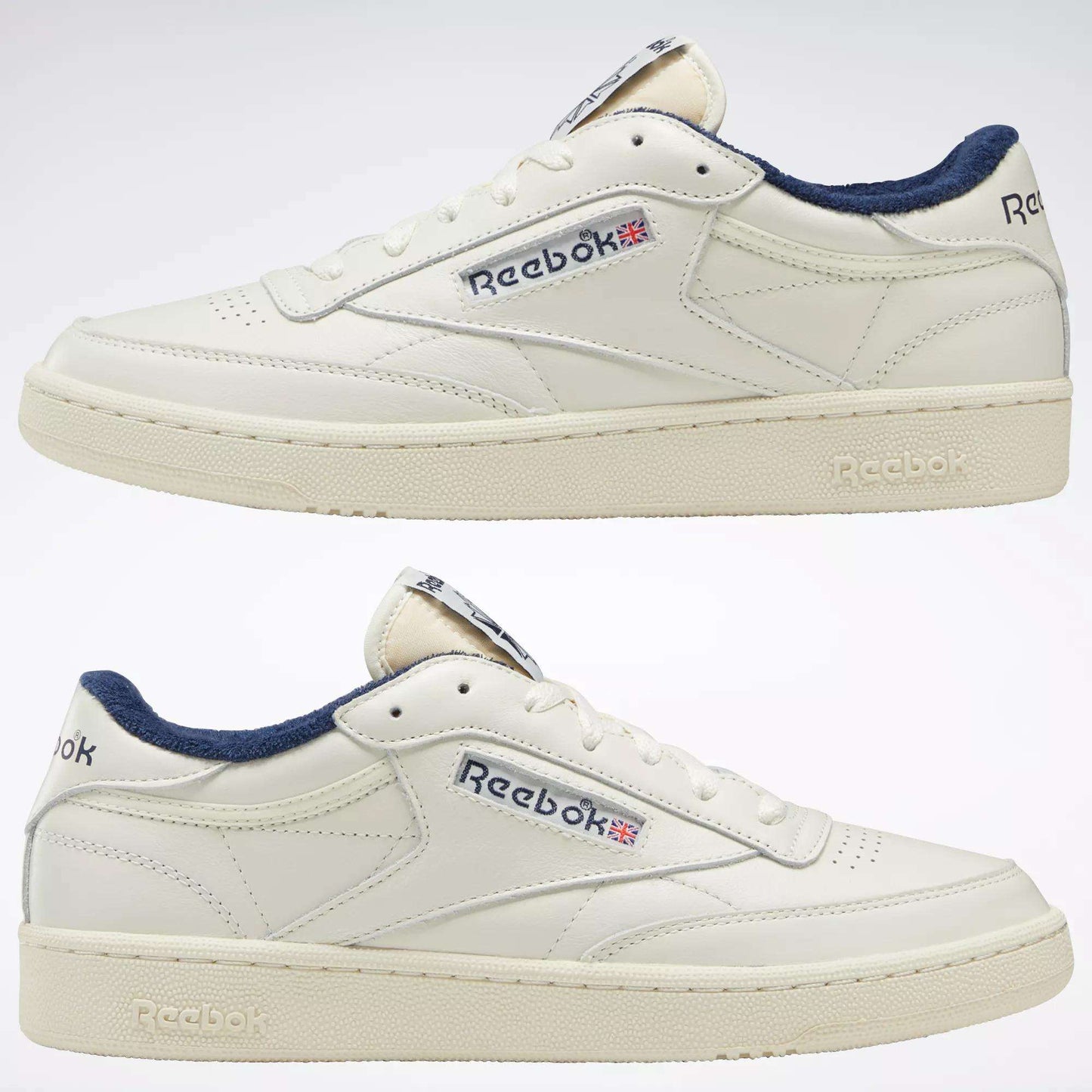 The Reebok Club C 85 Vintage Shoes are shown side view against a white background, featuring a durable white leather upper, navy blue lining, and the iconic Reebok logo with a small Union Jack flag on each side.