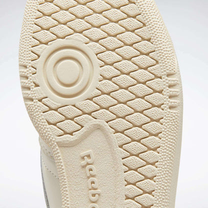 Close-up of the textured beige sole of a Reebok Women's Club C 85 Vintage Shoe, showing a circular pattern and the embossed Reebok logo.