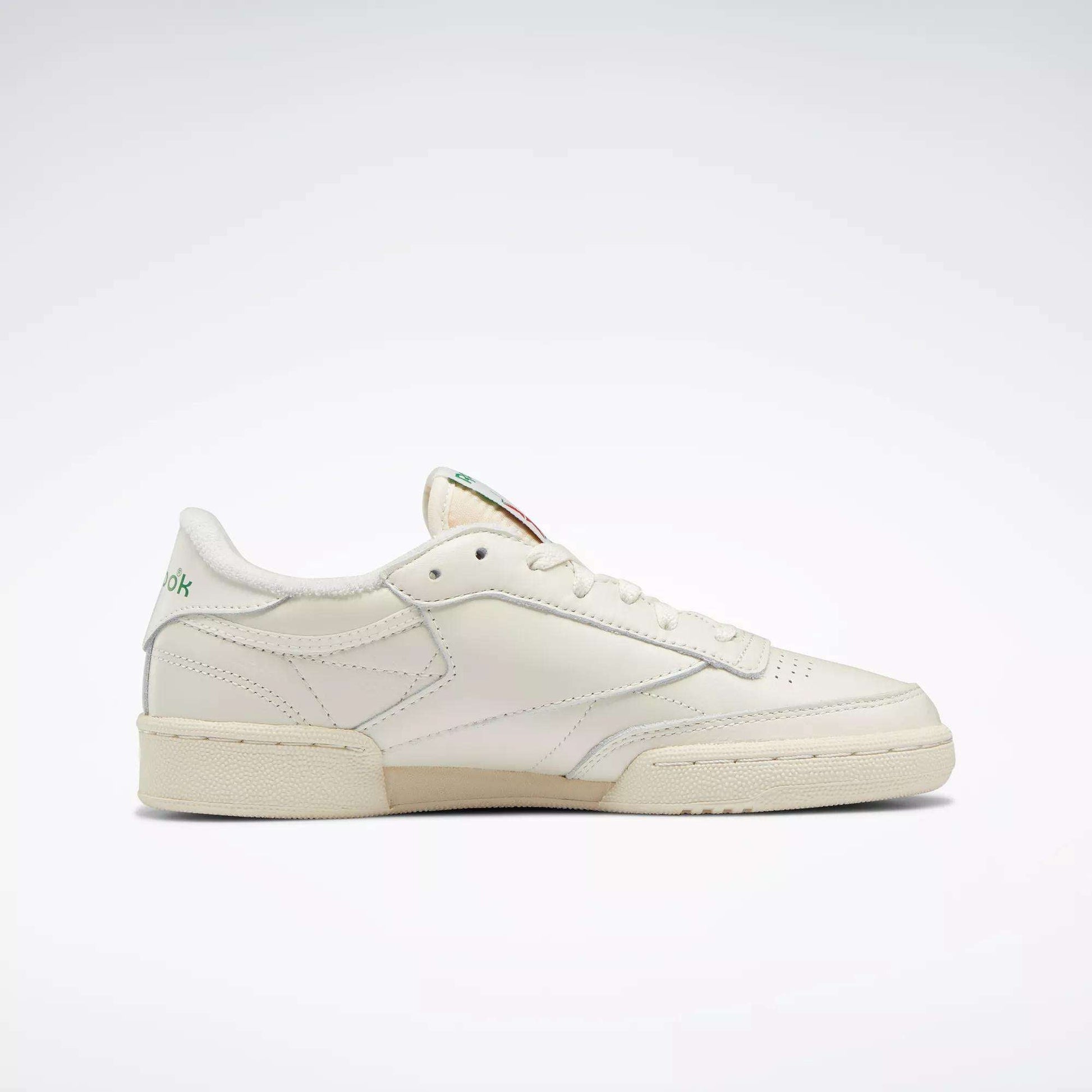 The Reebok Women's Club C 85 Vintage Shoes are shown in cream from the side against a white background. This women’s leather tennis shoe features a low profile, minimal design, and subtle stitching for stylish everyday wear.