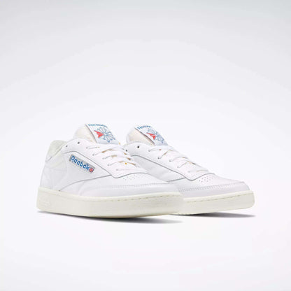A pair of Reebok Club C 85 Vintage Shoes with a white leather upper, blue and red branding, off-white soles and laces, displayed against a plain light background.