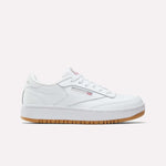 The Reebok Club C Double Shoes - Big Kids feature a white leather upper, low-top design, white laces, subtle Reebok branding, and a light brown gum sole, shown against a plain white background.
