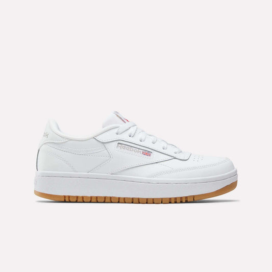 The Reebok Club C Double Shoes - Big Kids feature a white leather upper, low-top design, white laces, subtle Reebok branding, and a light brown gum sole, shown against a plain white background.