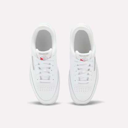 The Reebok Club C Double Shoes for big kids feature a leather upper, white laces, and a red Reebok logo on the tongue—seen from above on a light background—making them the perfect classic girls' shoes.