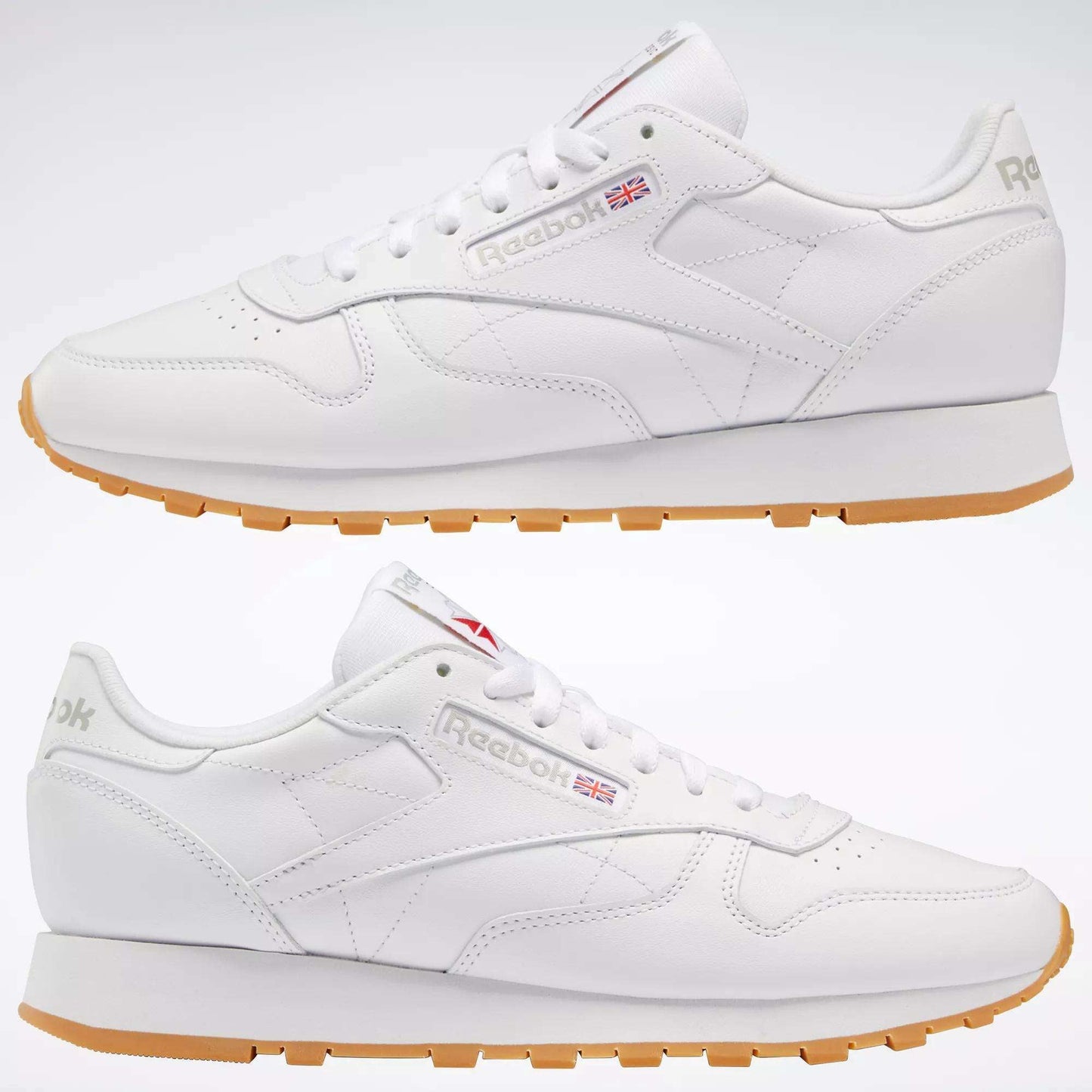Two Reebok Classic Leather Shoes in white with gum soles are shown side view, featuring the Reebok logo and UK flag. Their durable leather build and minimalist retro design make Classic Leather Shoes timeless and stylish.