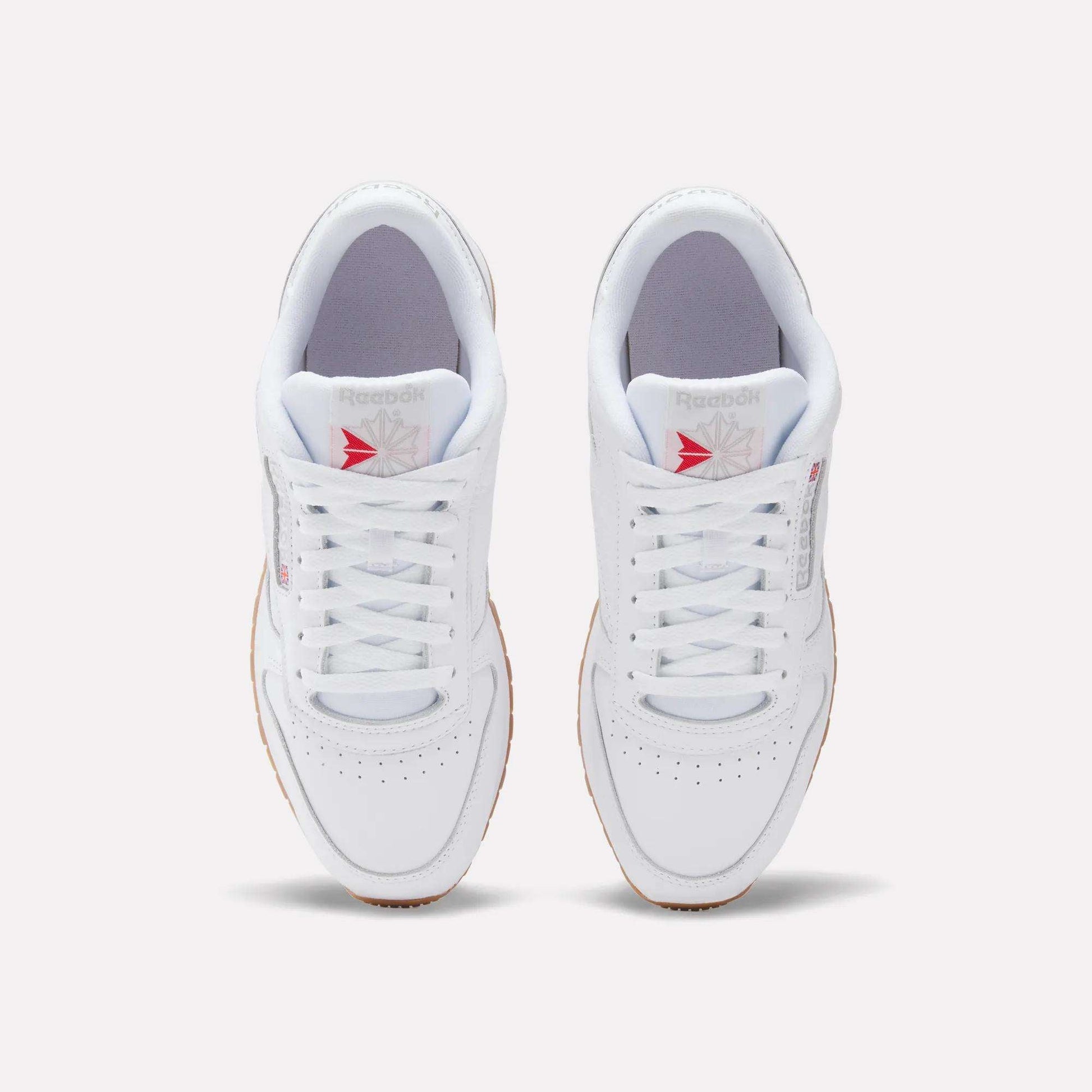Top view of Reebok Classic Leather Shoes with a leather upper, gum soles, white laces, and the gray/red Reebok logo on the tongue, displayed on a plain light background for retro flair.
