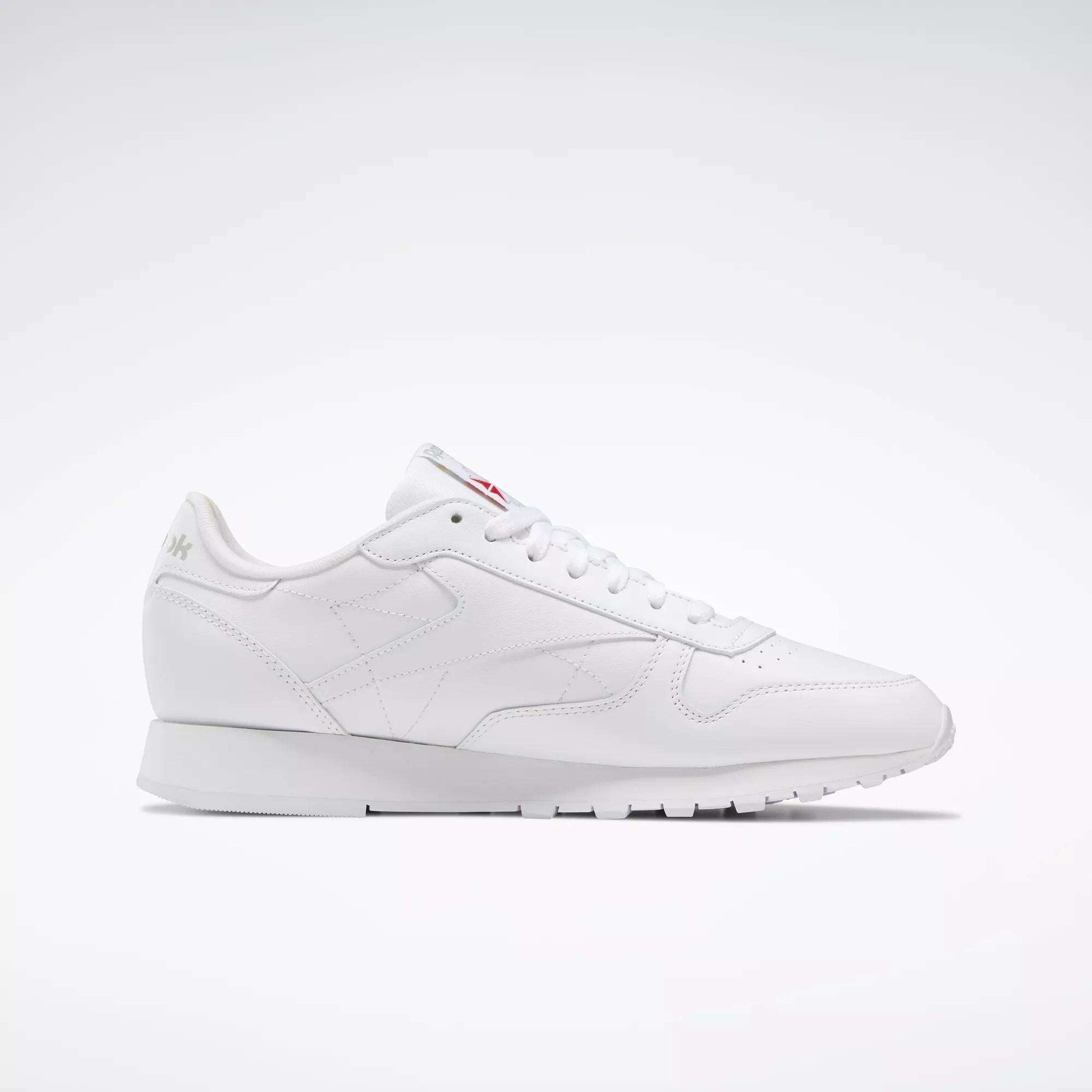 The Reebok Classic Leather Shoes are white low-top sneakers inspired by retro designs, with white laces and subtle branding, shown against a simple light background.